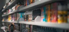 woman in black shirt standing in front of store shelf