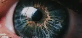 person showing left green eye